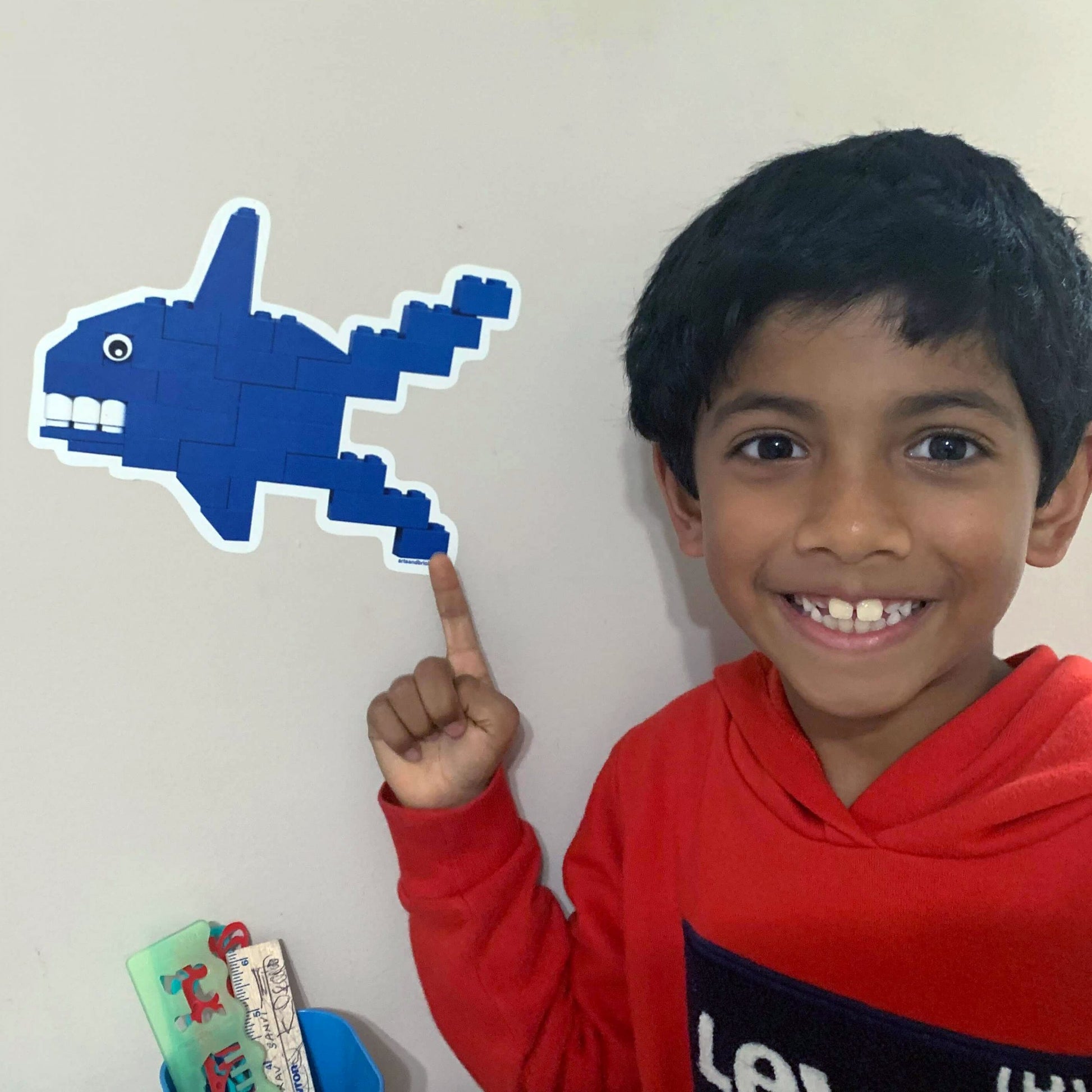 Image of child with baby shark wall decal displayed on wall