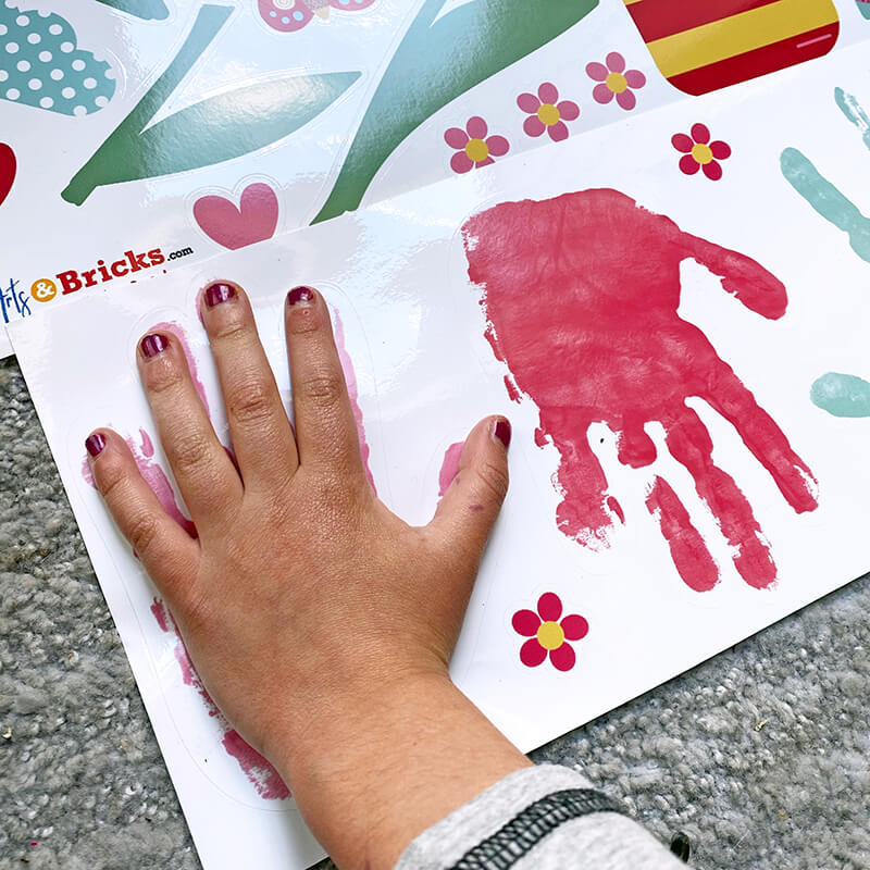 Image of child creating personalized handprint window cling 